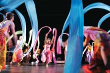 Photo of dancers in bright costumes.